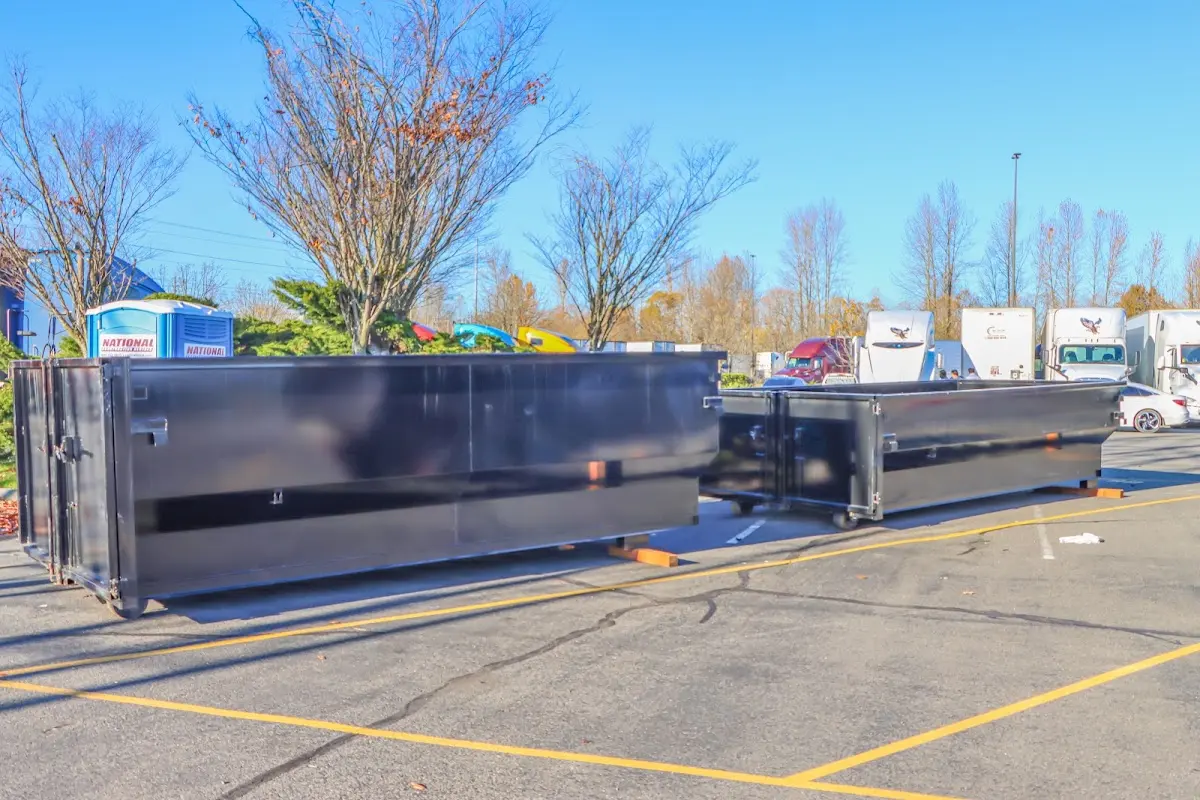 Professional dumpster rental service with roll-off container on residential driveway in Glens Falls